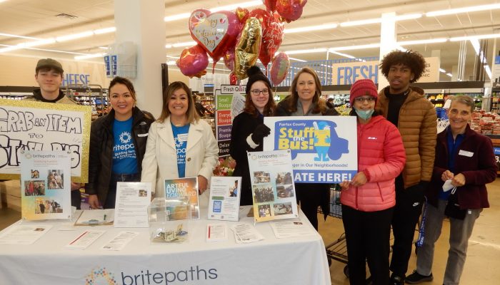 Britepaths' staff and volunteers, including our Board President Emily Barnes, at Stuff the Bus. Photo by Bonnie Hobbs, Connection Newspapers