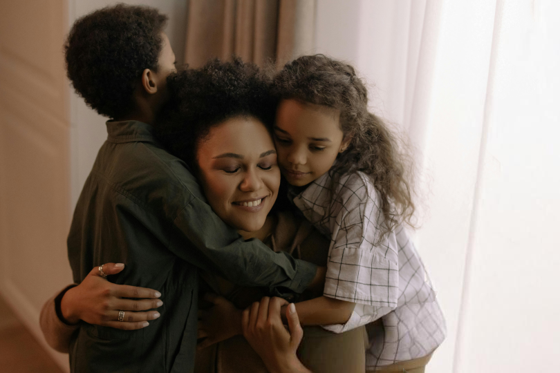 Canva- a woman hugging her children2 1 Canva- a woman hugging her children2 1